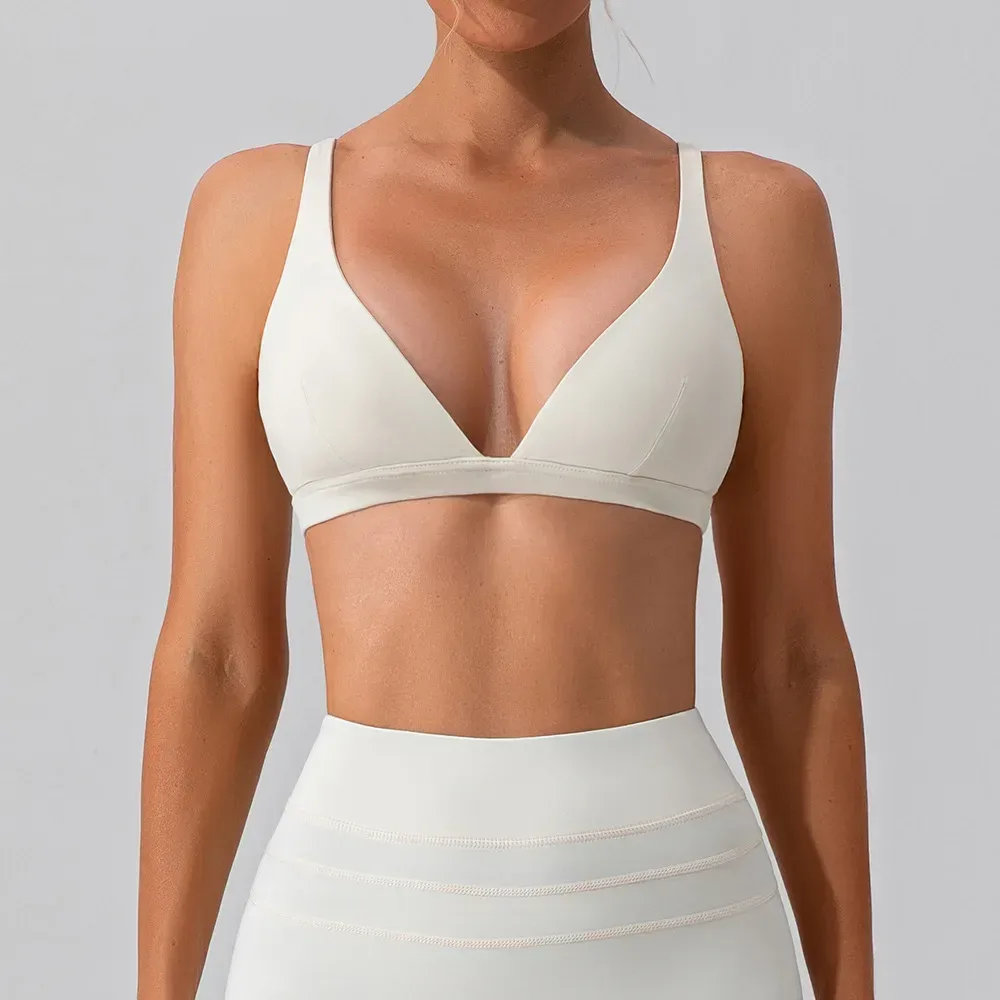 front view of the beige deep V neck sports bra showing the plunging neckline