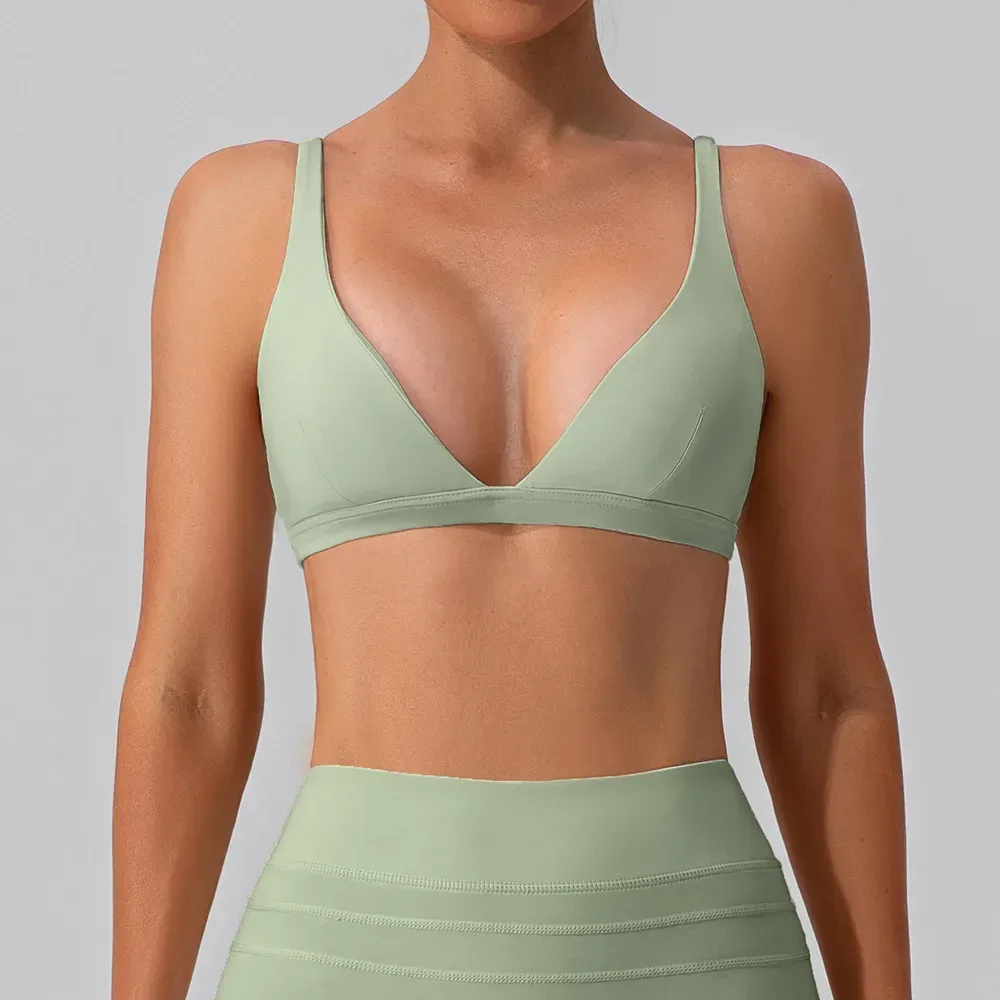 sage green deep V neck sports bra worn with leggings