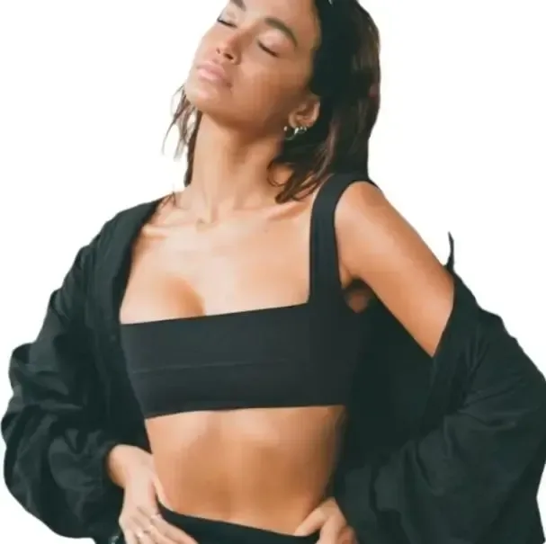 black square neck sports bra worn under an oversized jacket