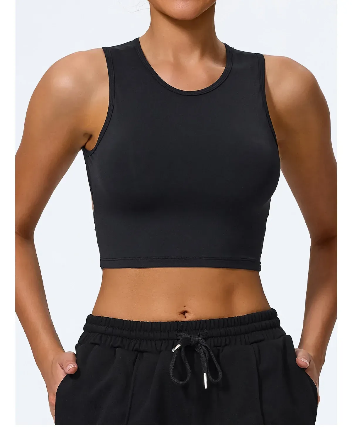black crop tank top worn with black joggers