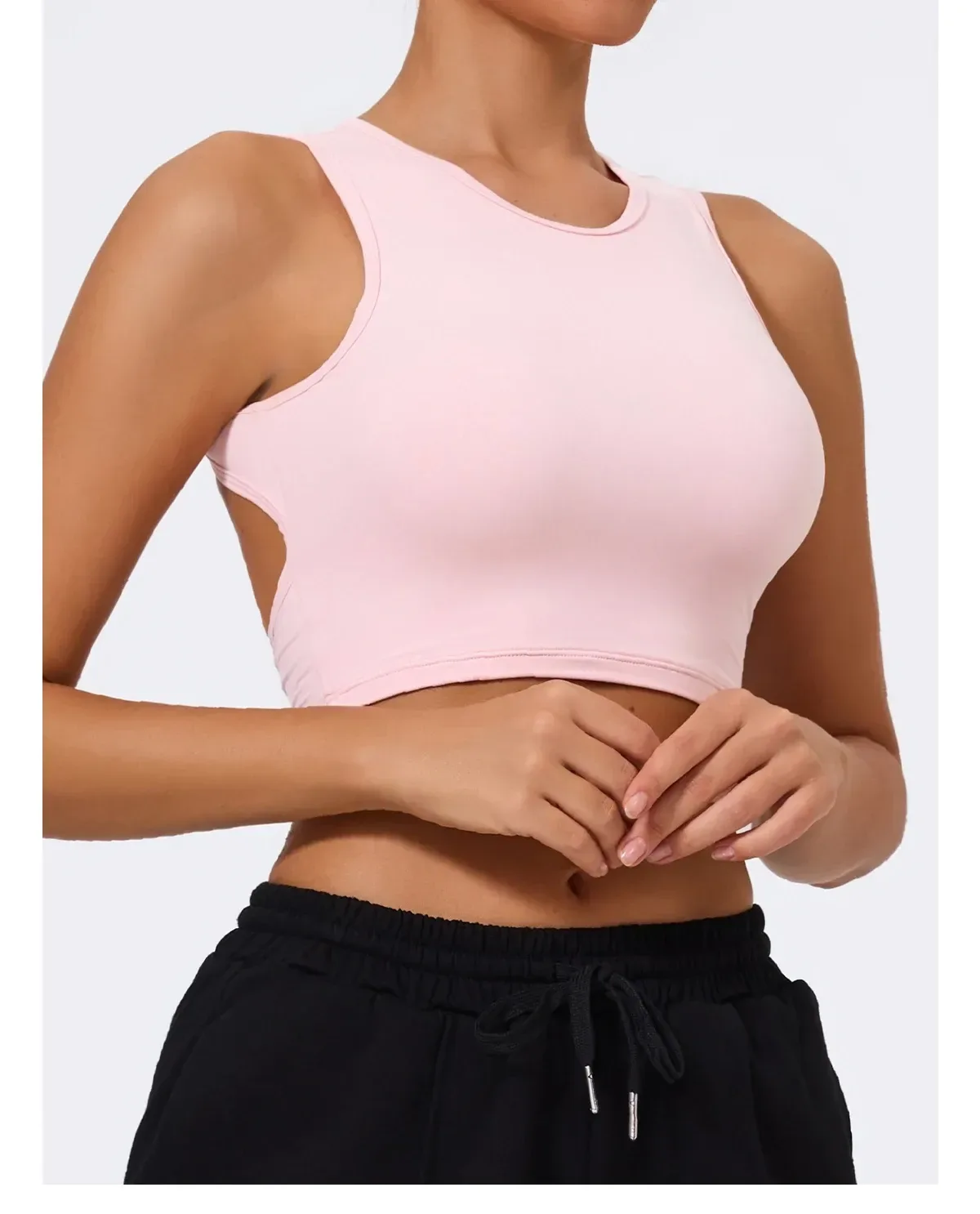 pink open back crop tank top on a model, side view