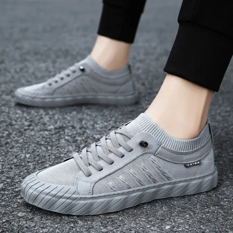 grey mesh sneakers worn on the street